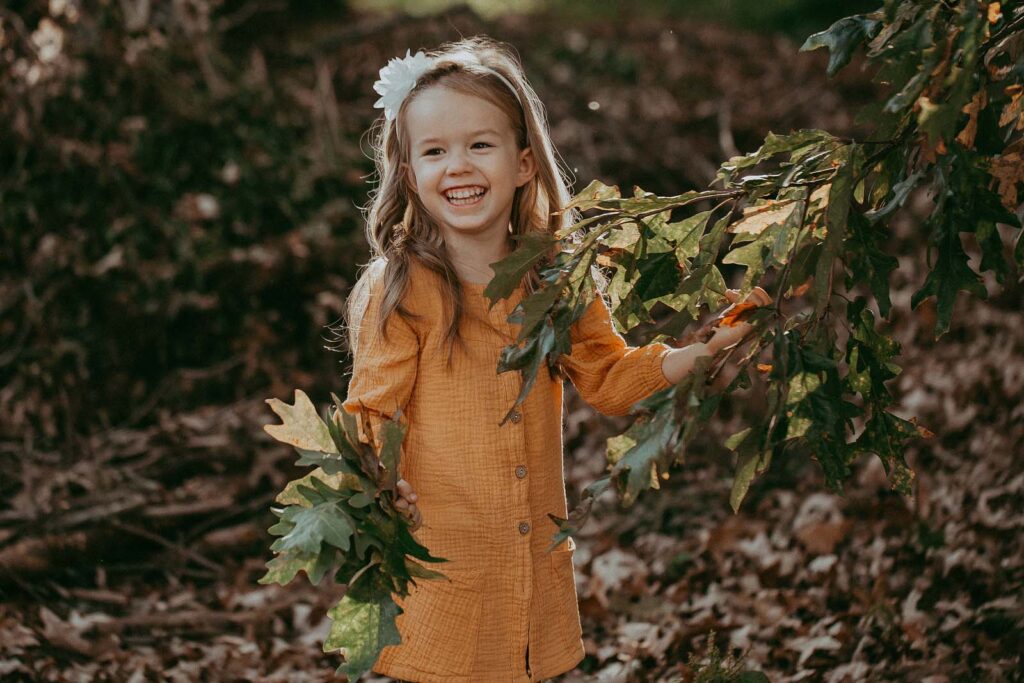 4 years old girl in yellow dress picks leaves, ithings to do in Durham NC at Fall