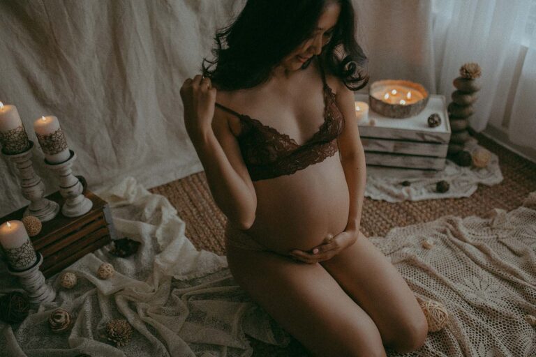 pregnant asian mama with long black hair in brown lace bra posing in photography studio near baby shower venues in raleigh