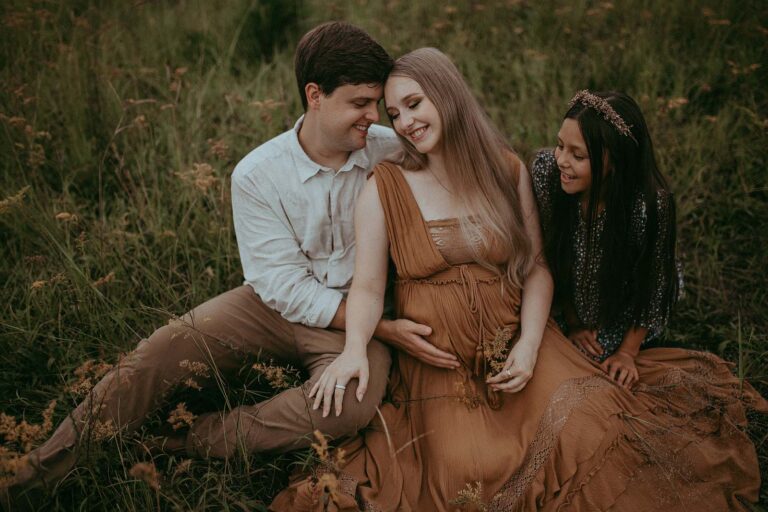 family of 3 posing for raleigh maternity photographer in raleigh near rex center