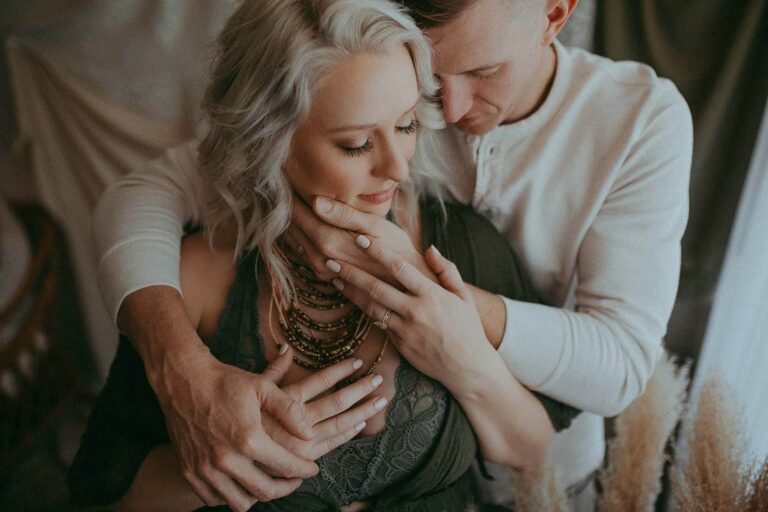 Husband and wife hug each other and close their eyes. Portrait was taken by Victoria Vailyeva Photography studio.