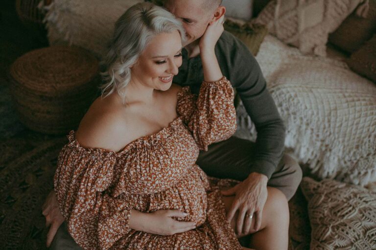 husband and wife are posing to maternity photographer near Durham Prenatal Yoga studios