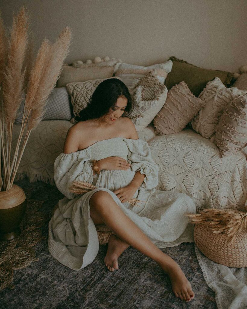 Tender portrait of pregnant woman in boho styled studio was taken by Raleigh maternity photographer - Victoria Vasilyeva Photography.