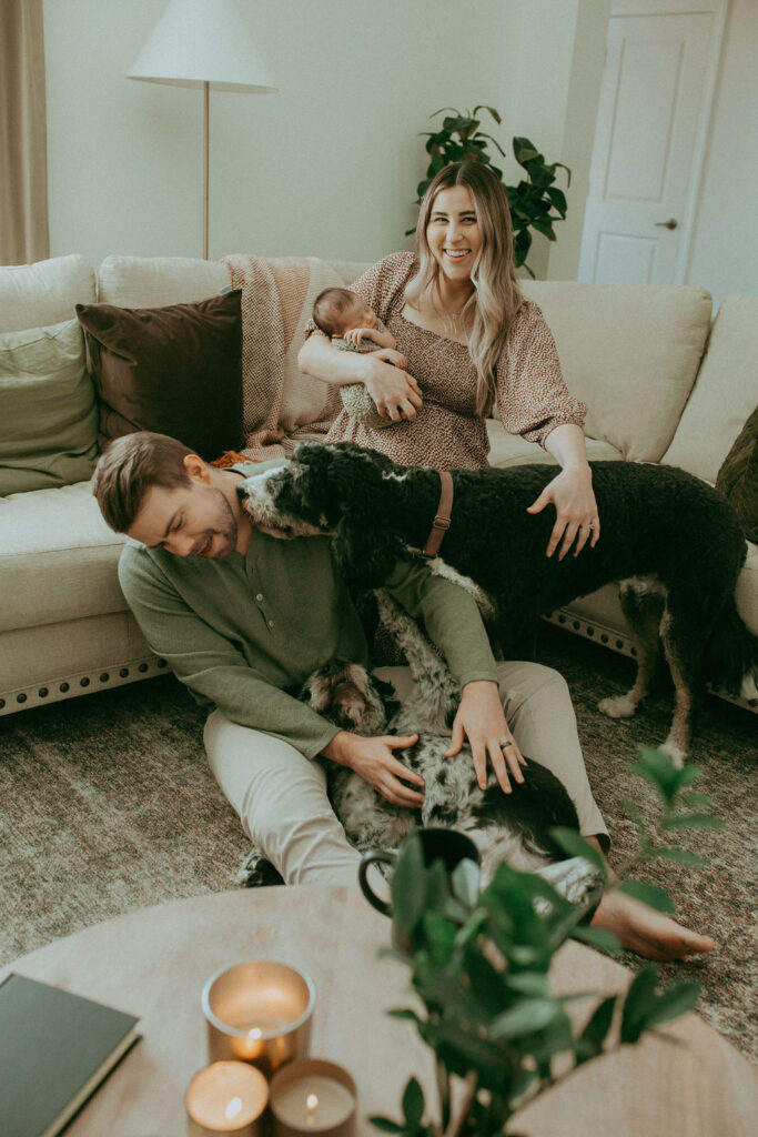 Family of 3 and 2 dogs are having fun in the living room. The home is decorated in boho style with a lot of muted colors. Photo was taken during newborn photo session with Victoria Vasilyeva Photography.