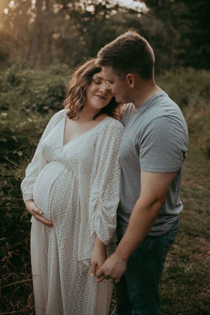 Embrace the beauty of motherhood in this stunning outdoor maternity photo session by Victoria Vasilyeva Photography. Join a radiant mom-to-be and her husband at Crabtree Lake Park near Durham NC.