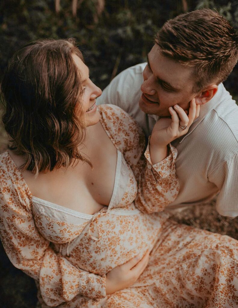 Fayetteville's outdoor maternity photography at its finest! Victoria Vasilyeva Photography brings to life the radiant mom-to-be in a breathtaking floral maxi dress. Photo session took place near Fayetteville doulas.