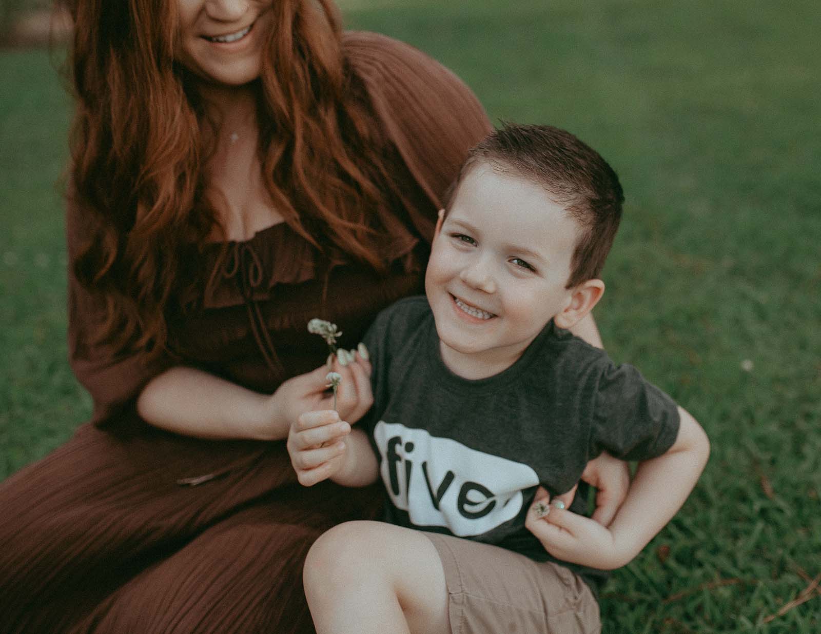 A mother and son enjoy a day out in Raleigh, NC. They are taking a photo near North Raleigh Pediatricians. Raleigh Family Photographer - Victoria Vasilyeva Photographer.