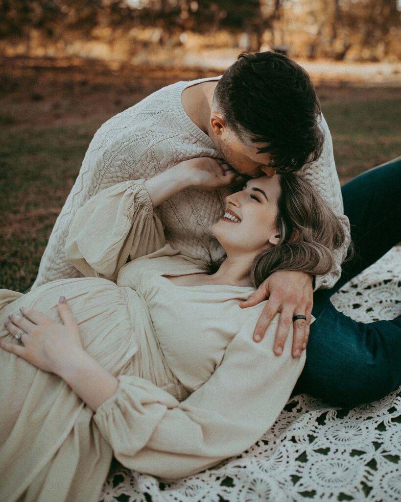 A charming family portrait unfolds at the Greensboro birthing center, highlighting the expecting mom and dad, in these beautiful maternity shots by Victoria Vasilyeva Photography.
