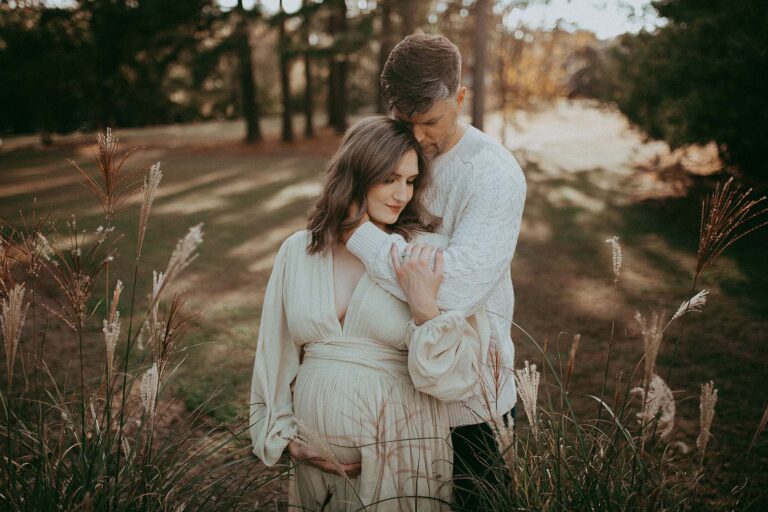 Radiant maternity portraits featuring a mom-to-be and dad-to-be, captured by Victoria Vasilyeva Photography at the Greensboro birthing center.