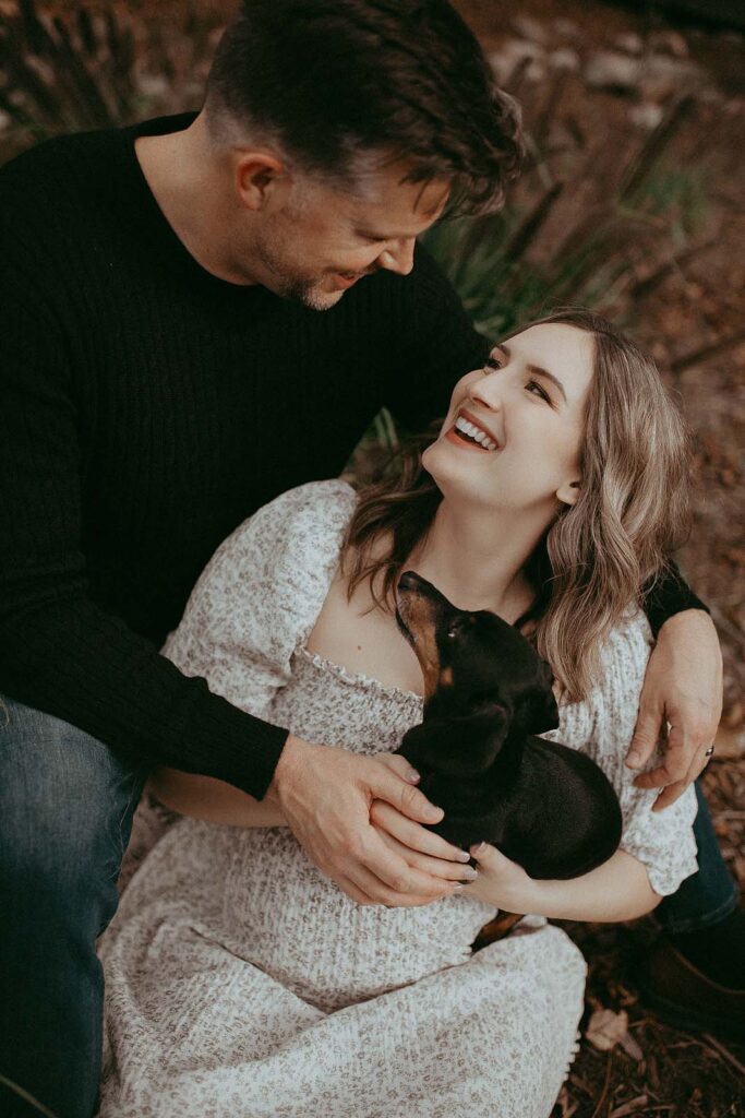 A beautiful moment captured near Greensboro birthing center: A glowing mom-to-be, a proud dad-to-be, and their dachshund eagerly awaiting the newest family member.