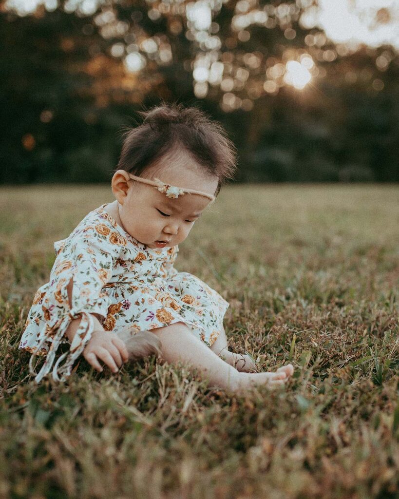 Captivating baby portraits capture the delightful moments of a family outing in Fayetteville with their 10-month-old daughter.