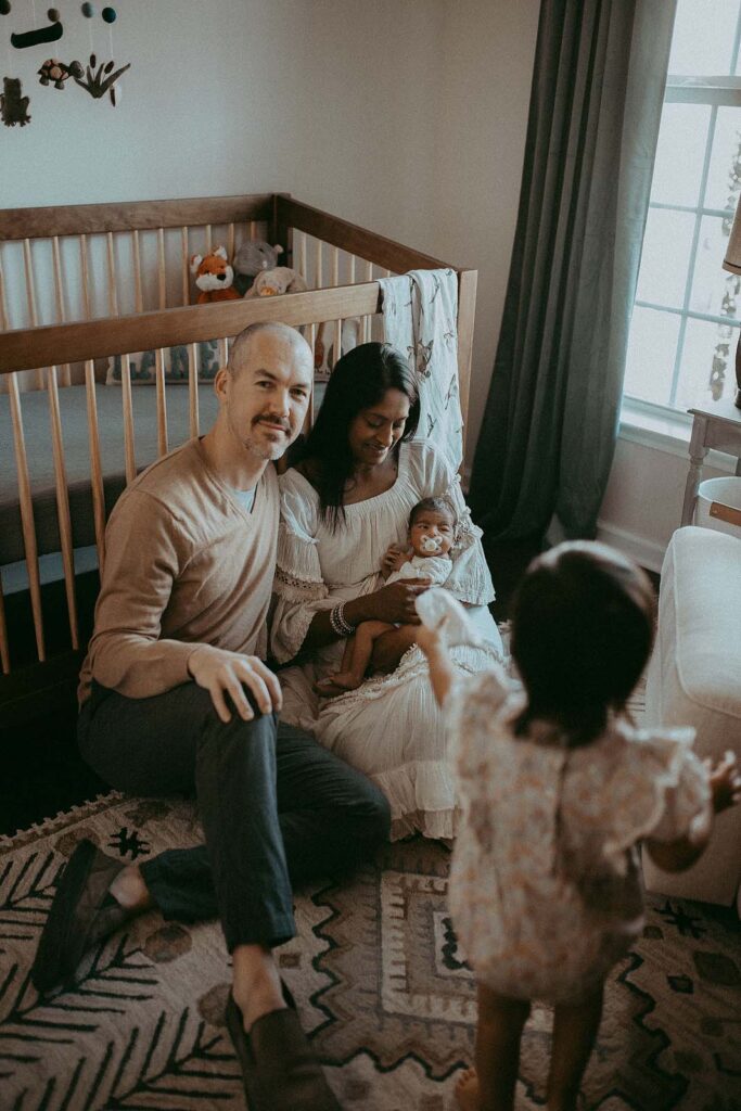 Newborn bliss surrounded by earthy hues, as the family poses for Victoria Vasilyeva Photography near Carrboro Midwifery.