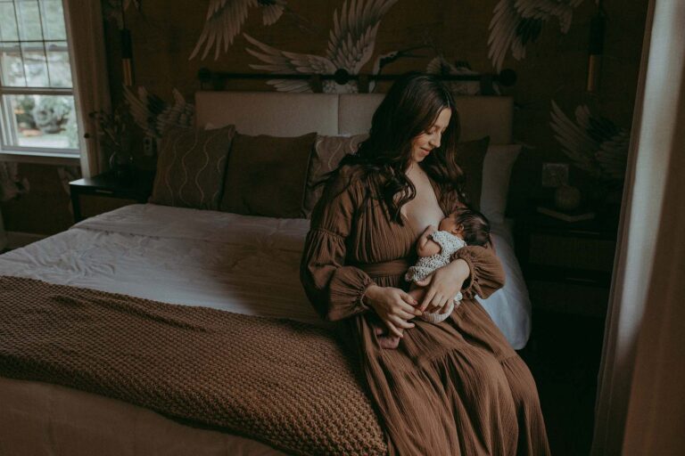 Victoria Vasilyeva Photography beautifully captures the essence of a newborn portrait session near Duke Perinatal Durham, highlighting the breastfeedingl moments.