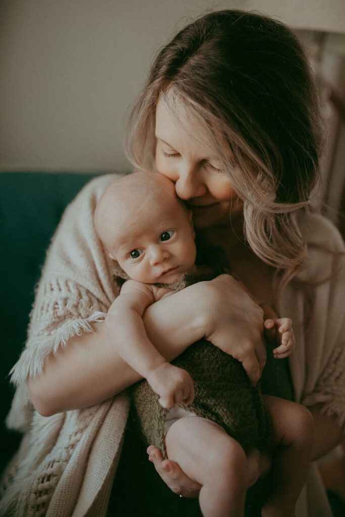 The portrait of newborn baby boy with his mom. Newborn photography in Cary, NC. Victoria Vasilyeva Photography specializes in lifestyle photography, using natural light. Certified, insured, professional, safety. All outfits for baby, mom, and siblings are provided.
