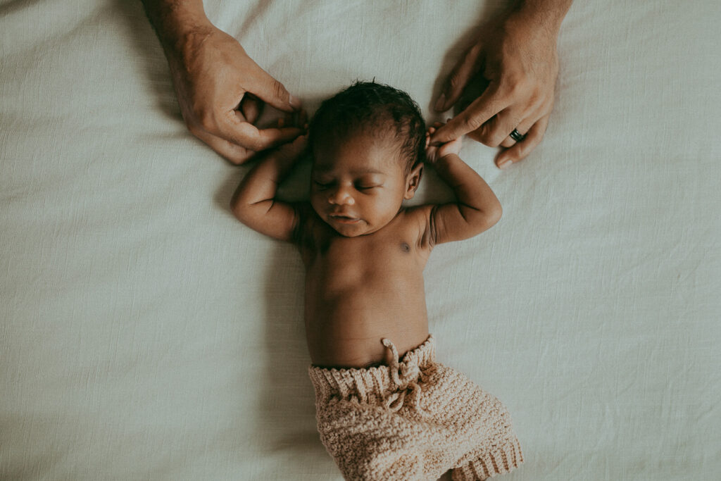 Newborn photo session with a baby boy and his parents. The portraits were taken by Victoria Vasilyeva Photography - a family photographer in Fayetteville, NC.