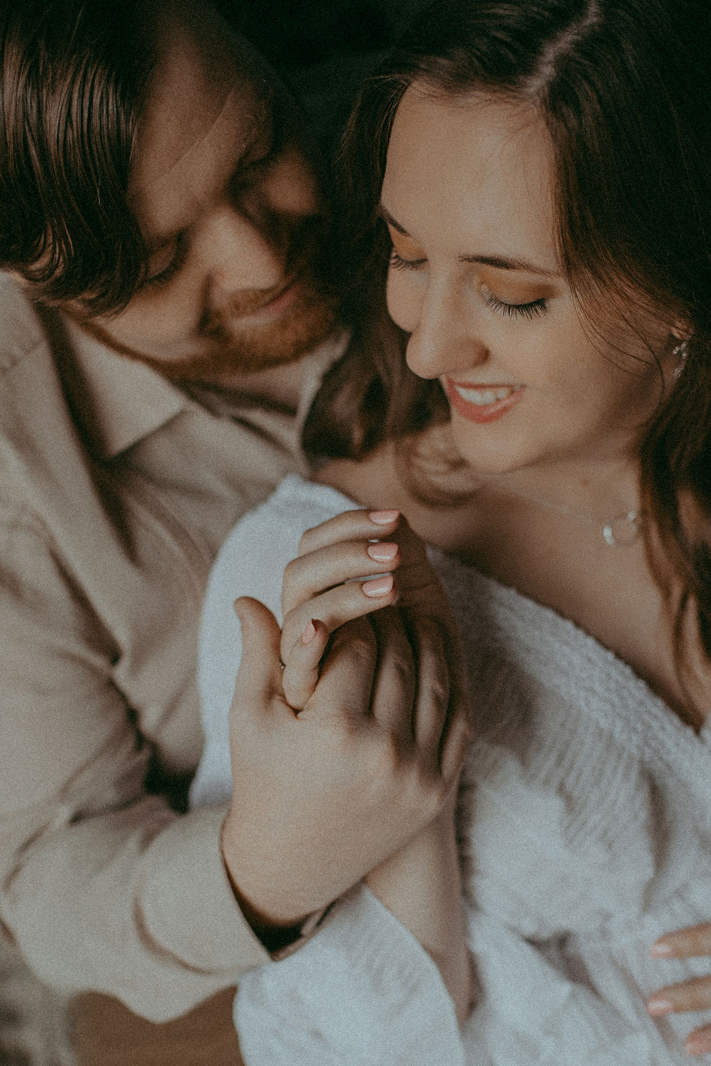 Studio portrait by Victoria Vasilyeva Photography (Greensboro NC). Mom, radiant in white lace, and Dad, beaming, celebrate their upcoming parenthood. Birthing Centers Greensboro NC