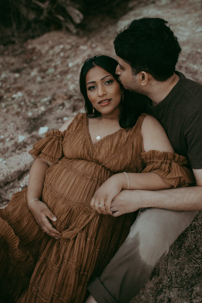 A dreamy maternity session near a peaceful Fayetteville lake, featuring an elegant mother-to-be in soft evening light.