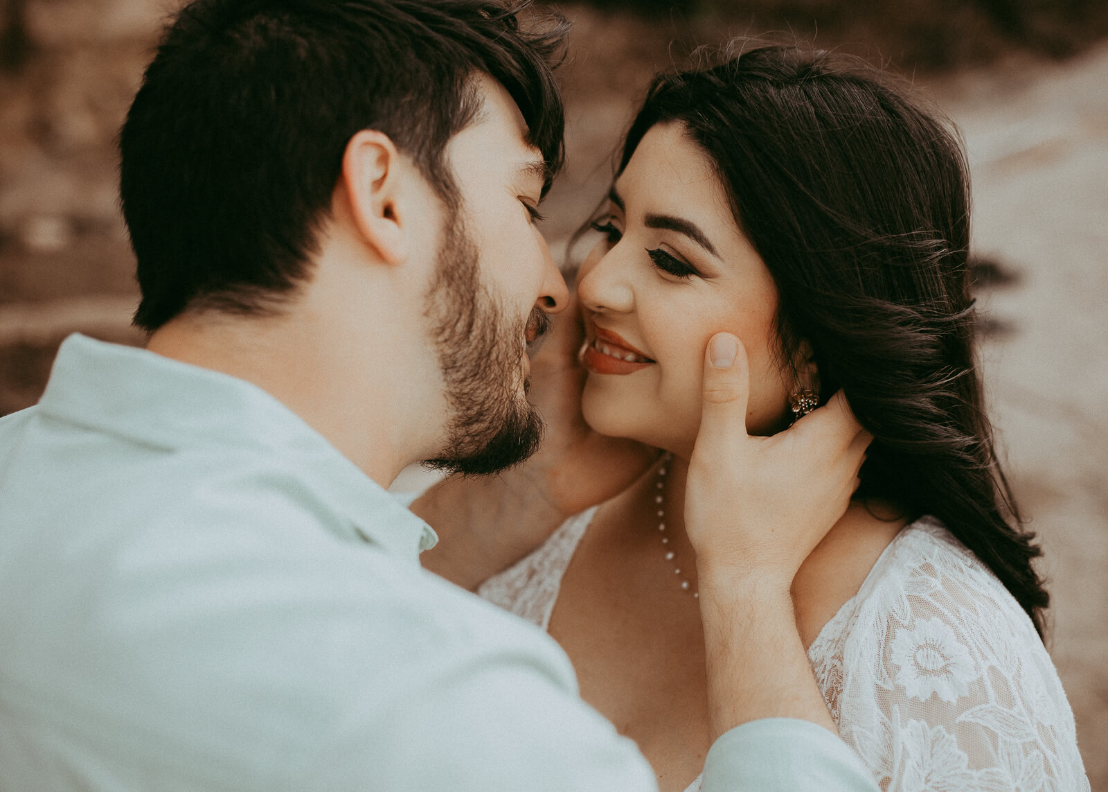 A romantic maternity session by the lake, with the mom-to-be in a lace dress holding her belly while her partner gently kisses her cheek. The portrait was taken by Cary maternity photographer - Victoria Vasilyeva Photography.