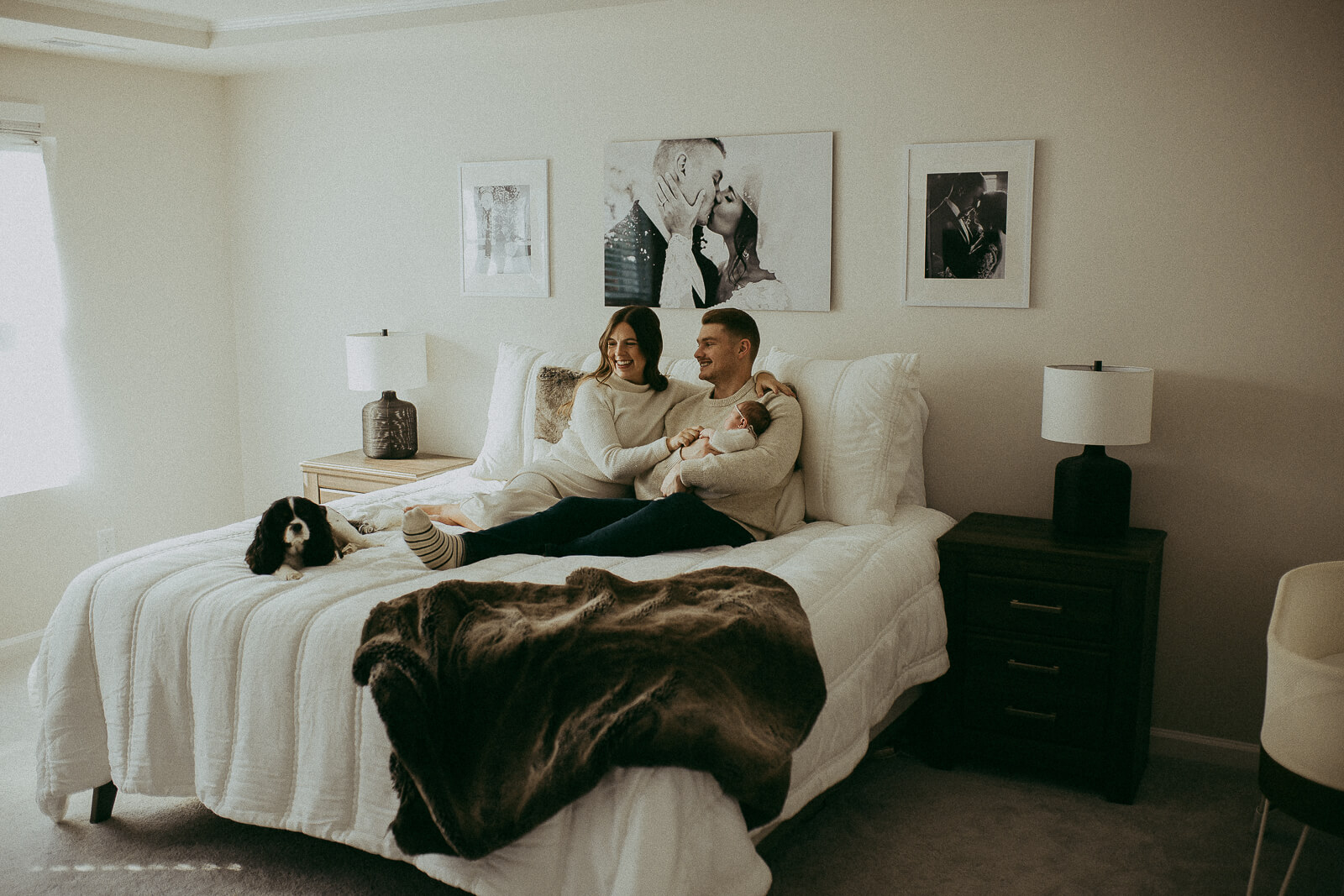 A joyful family gazes at their newborn daughter with love, creating timeless memories during a Victoria Vasilyeva photography session. Pediatricians in Fayetteville, NC