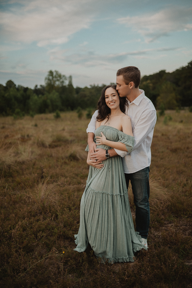 Expecting couple in soft sunset light during outdoor maternity session. Captured by Raleigh maternity photographer - Victoria Vasilyeva Photography.