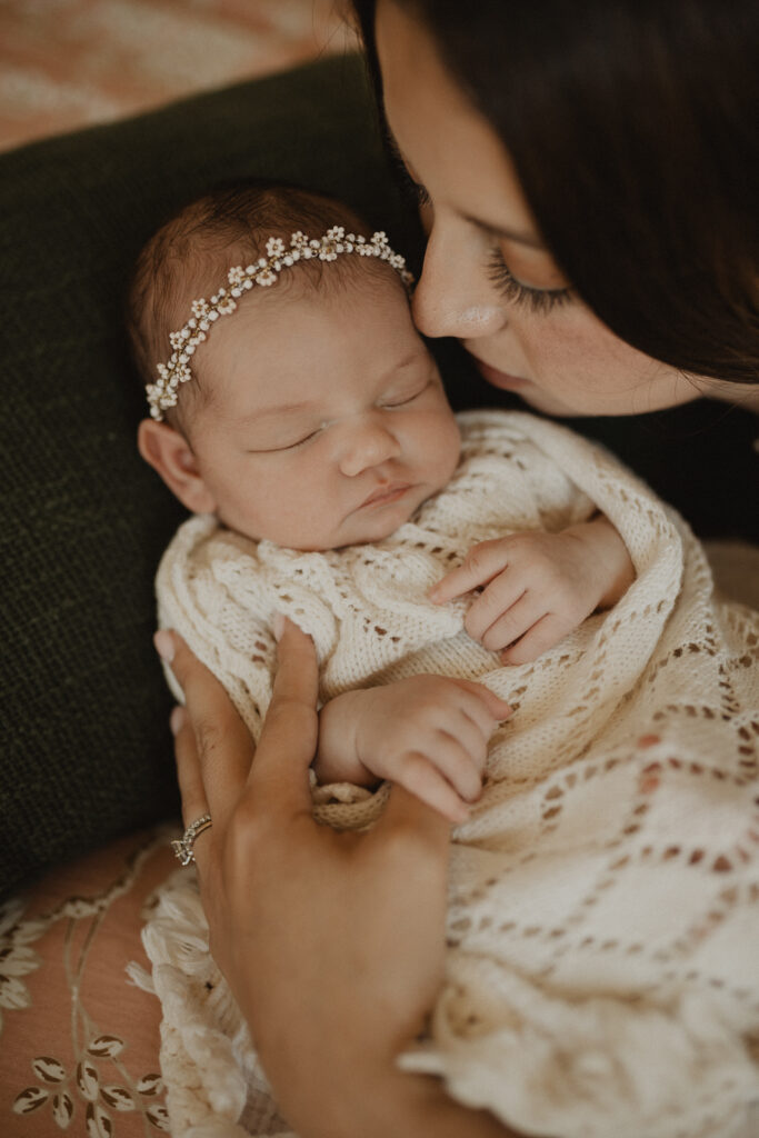 Close-up portrait of a newborn baby resting in mother's arms during a natural newborn photography session with Cary newborn photographer - Victoria Vasilyeva Photography.