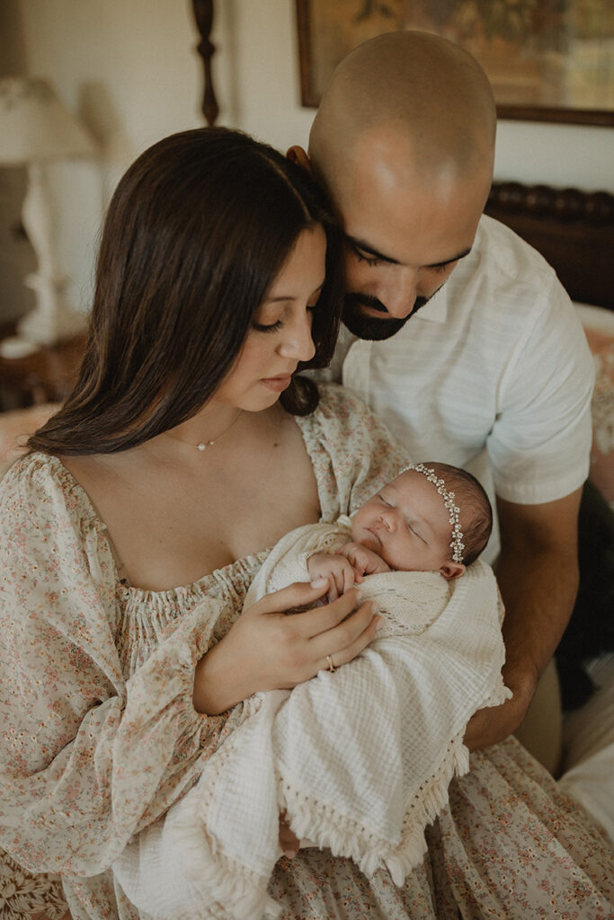 Family welcoming their newborn during an in-home lifestyle session inspired by support from a breastfeeding consultant in Cary, NC.