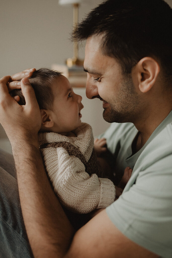 Father and baby sharing a sweet face-to-face moment during an in-home lifestyle session.