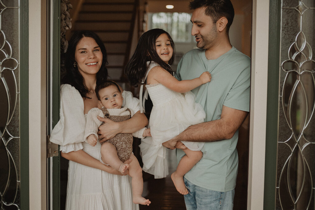 Chapel Hill family photographer Victoria Vasilyeva Photography capturing a cozy family portrait with parents, toddler daughter, and baby boy gathered together.