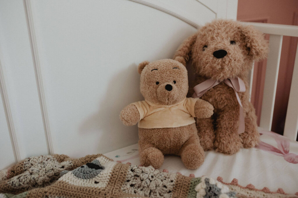 Sweet nursery details with teddy bears and a handmade baby blanket during an in-home newborn photography session in Raleigh NC.