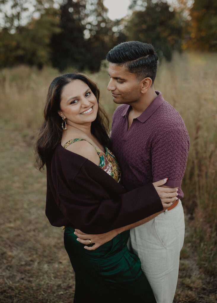 Couple embracing outdoors during a fall pumpkin patch family photography session by Victoria Vasilyeva Photography - Raleigh NC family photographer.
