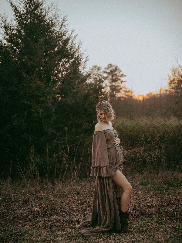 Captivating image of a pregnant woman in a maxi dress, radiating tenderness and romance during her sunset maternity session in Raleigh, NC. The portrait was taken by Raleigh maternity photographer - Victoria Vasilyeva Photography.