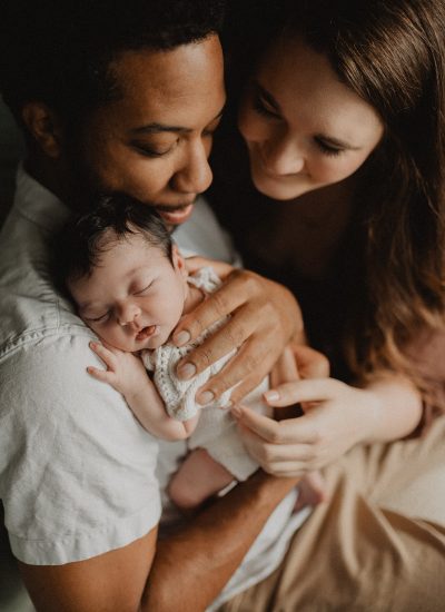family of 3 with newborn girl is posing to winston-salem nc newborn photographer.